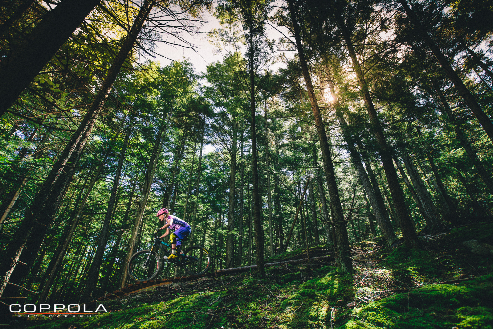 Coppola Photography: Clarissa Finks. Little Bellas Women's Mentor Pro Mountain Bike images shoot, adventure, movement, light through trees, cyclist, Vermont. CT.
