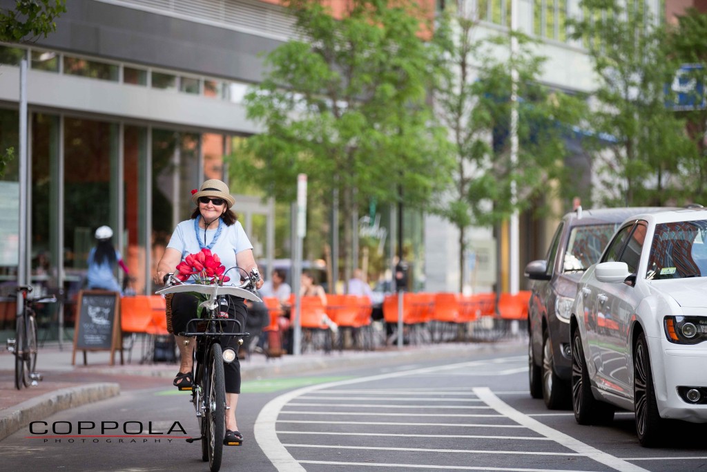 Coppola Photography Boston Bike Image Woman in City Biking Safe Roads and Smiling