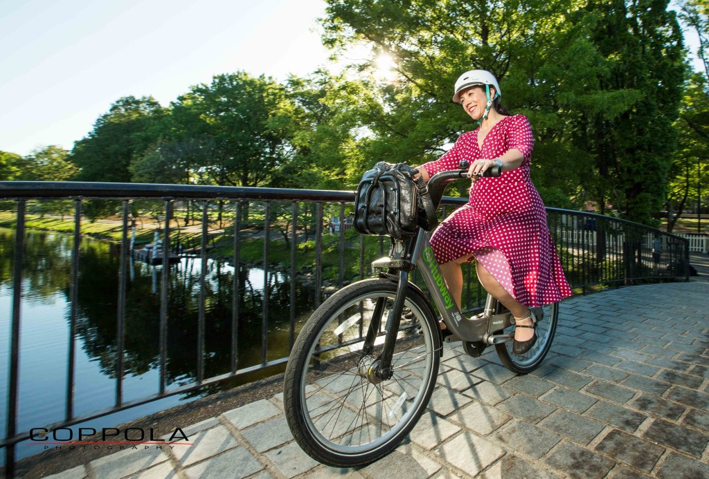 Coppola Photography Boston Bike Photo Woman in Red Dress Over River with Hubway Bike Share