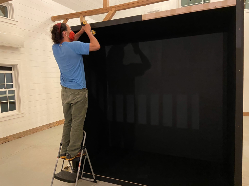 Man constructing a large box in a studio