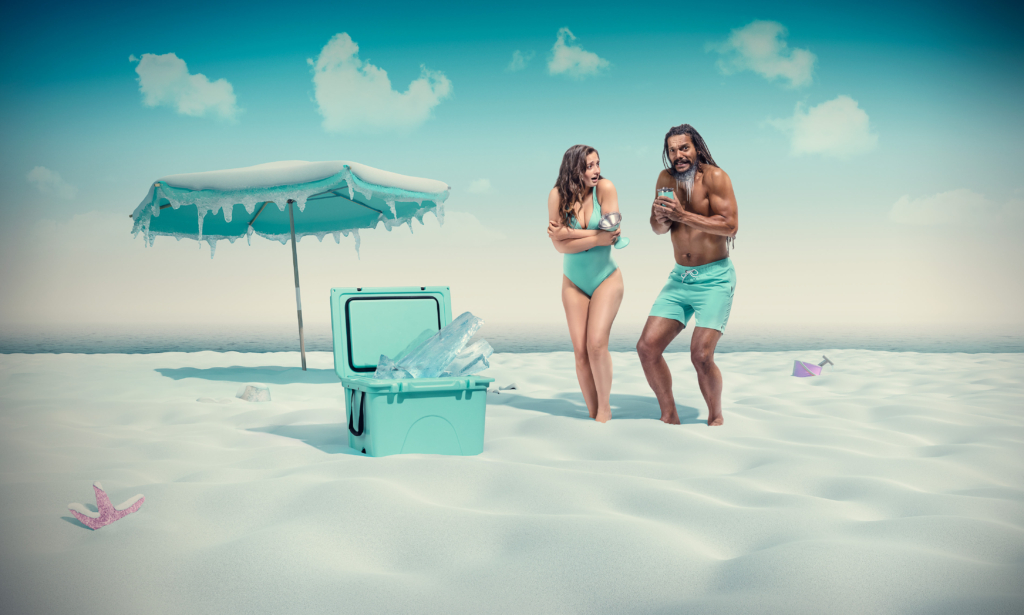 Series Image 3 of 3: The cooler has turned the whole beach scene frozen, and the man and woman are still in their swim wear, but are freezing cold.